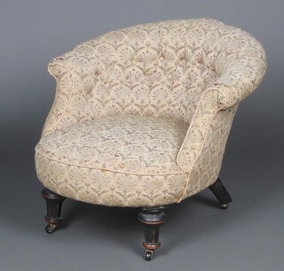 A Victorian tub back armchair upholstered in buttoned floral material, raised on later casters  62cm h x 70cm w x 53cm d 