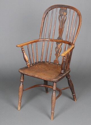 A 19th Century elm and beech hoop and stick back carver chair with solid seat, raised on turned supports with cow horn stretcher 105cm h x 59cm w x 40cm d 