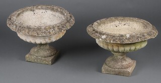 A pair of circular well weathered concrete garden  urns on square bases, in 2 sections 40cm h x 56cm diam. 