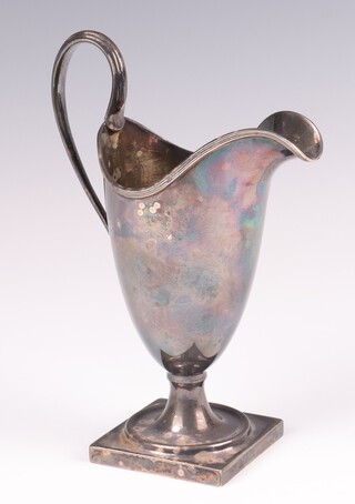 A Georgian style silver helmet shaped cream jug raised on a square foot, Birmingham 1924, maker A Marston & Co. 150 grams 
