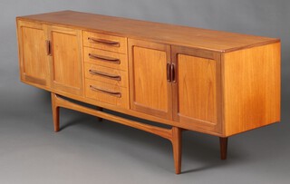 G-Plan, a mid-century sideboard fitted 4 drawers, flanked by cupboards enclosed by panelled doors, with counter sunk handles 79cm h x 213cm w x 45cm d 