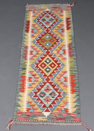 A yellow, green and turquoise ground Chobi Kilim runner with 4 diamonds to the centre 153cm x 53cm 
