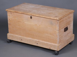 A 19th Century pine carpenter's chest with original long hinges and iron drop handles to the sides, the interior fitted 2 trays, raised on later casters 54cm h x 91cm w x 48cm d 