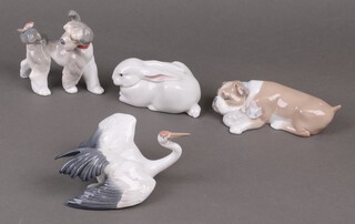Four Lladro figures - Stork 1596 15cm, bulldog with puppy 6417, a rabbit  and dog with bird 