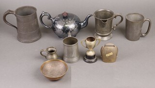 A pewter quart tankard, a Victorian spouted pewter pint tankard, 3 other tankards, a silver plated teapot, metal bell, bowl and saucer and a small plated trophy cup 