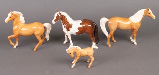 A Beswick figure of a Palomino foal 10cm, 2 ditto horses 7cm, ditto piebald 6.5cm 