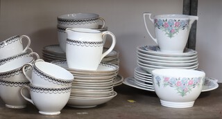 A 39 piece Foley white and black tea service with swag decoration comprising 12 tea plates (2 cracked), large cup and saucer, 9 cups (3 cracked), 12 saucers (2 cracked), cream jug and sugar bowl together with a 16 piece Minton May Time tea service comprising brea plate, 6 tea plates, 6 saucers, cream jug, sugar bowl and small saucer