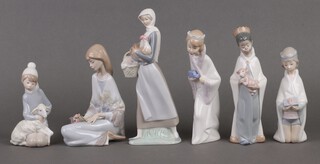 Six Lladro figures including The Three Kings, seated girl with lamb, seated lady with flowers and a standing lady with chicken and basket 