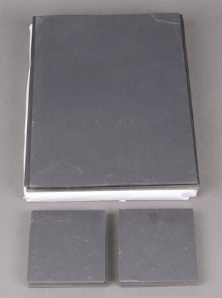 A collection of slate table mats and glass coasters