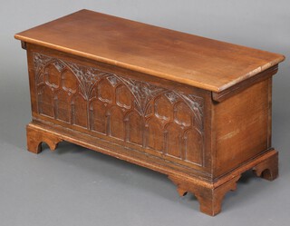A carved oak coffer with hinged lid on bracket feet 46cm x 93cm x 37cm (water marks) 