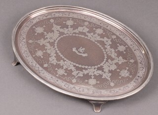 An oval silver plated salver with armorial and engraved floral decoration  35cm 