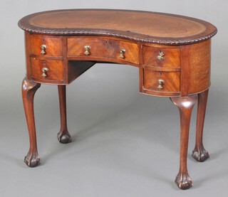 A 1940's Georgian style mahogany kidney shaped writing table with brown inset writing surface, raised on cabriole supports 74cm h x 99cm w x 48cm d 