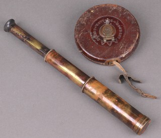 A 2 draw pocket telescope with brass case together with a leather cased surveyors tape measure 