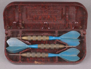 Three Unicorn darts contained in a brown Bakelite case 