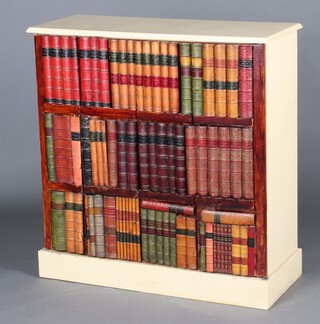 A yellow painted cabinet enclosed by panelled doors in the form of a bookcase with faux leather books, on a platform base 100 cm h x 96cm w x 39cm d  