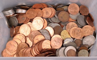 A collection of British coinage contained in a plastic box 