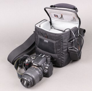 A Nikon DE60 digital SLR camera fitted a Nikon Nikkor 18-55mm lens together with soft carry case, charger and spare battery 