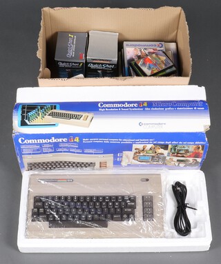 A Commodore 64 with original polystyrene and slip case together with power supply, tape deck, Quick Shot 1 and 2 joy sticks, a collection of leisure and educational games and games manuals 