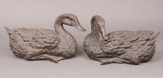 A pair of bronzed figures of seated ducks 17cm x 32cm x 14cm (chips in places, 1 has a section of tail missing) 