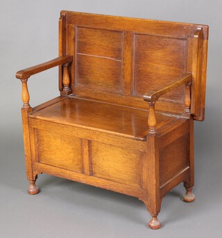 A light oak monks bench on bun supports 95cm h x 82cm w x 45cm d 