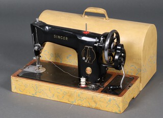 A Singer manual sewing machine no. EP4811643, contained in a yellow and turquoise painted carrying case 