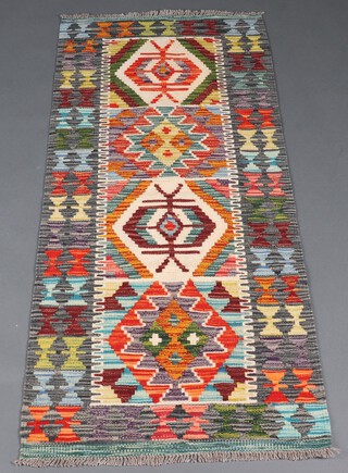 A turquoise and green ground Chobi Kilim runner with 4 medallions to the centre 152cm x 66cm 