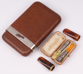 A Continental leather and 900 silver mounted cigar case 15cm x 10cm, a pair of Continental embossed silver plated cheroot holder and 2 amber coloured cigar holders  