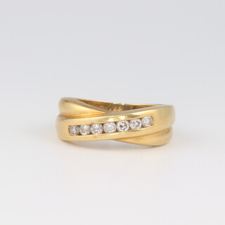 An 18ct yellow gold half eternity ring set 7 channel cut diamonds, size I 4.4 grams, 