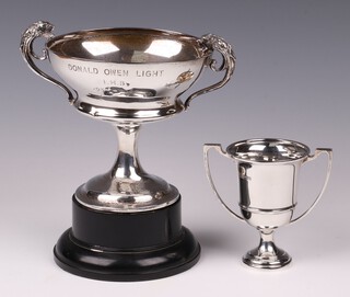 A silver twin handled trophy cup, with inscription, Birmingham 1913, by Henry Mathews 190 grams together with 1 other silver twin handled trophy cup Sheffield 1925 by Mappin & Webb 61 grams 