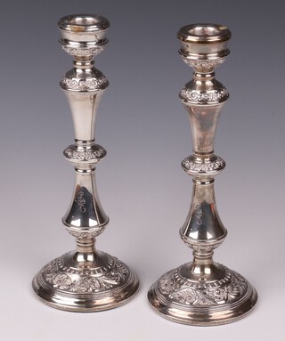 A pair of silver candlesticks Birmingham 1966, engraved A E, by W I Broadway & Co., 25cm high 