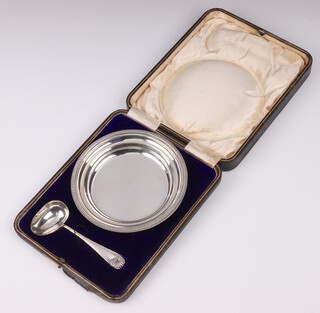 A circular silver bowl and spoon, Sheffield 1912 by Martin Hall & Company, 164 grams, cased