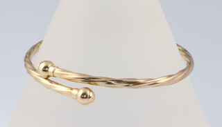 A yellow gold testing as 9ct hollow bangle, 4.2 grams 