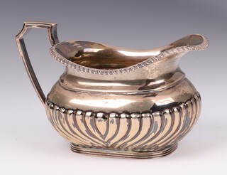 An Edwardian silver cream jug with demi-reeded decoration, Sheffield 1907 by Lee & Wigfull, 150 grams 