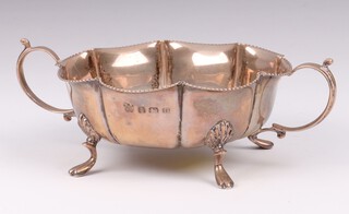 A silver twin handled bowl with wavy border on hoof supports, Birmingham 1938 by Martin Hall & Co., 97 grams