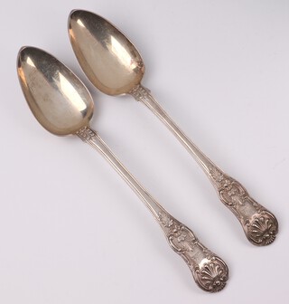 A handsome pair of George III Irish Britannia Standard Queens pattern silver serving spoons, with wild boars head armorial, Dublin 1804 by Patrick Moore, 469 grams 