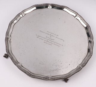 A silver salver with bracketed border, on ball and claw and feet with presentation inscription, London 1913, 30cm, by the Goldsmiths & Silver Smiths Company, 837 grams 