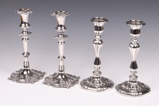 A pair of silver plated Rococo style candlesticks with detachable sconces 24cm and a similar pair of candlesticks 23cm 