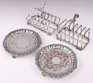 A 19th Century 7 bar silver plated toast rack (1 bar a/f), 1 other on bun feet (slightly misshapen) and a pair of 19th Century engraved silver plated salvers on panelled supports 18cm (plate worn in places) 