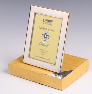 A silver easel photograph frame Sheffield 2000 with millennium hallmark by Carrs, 17cm x 13cm, boxed 