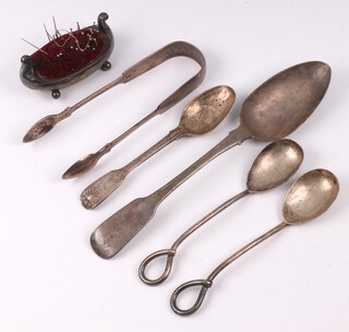 A Georgian silver fiddle pattern table spoon London 1815, a pair of Victorian silver Old English pattern sugar tongs London 1861, a pair of Victorian silver preserve spoons Birmingham 1845, a silver fiddle, thread and shell pattern teaspoon, a silver boat shaped pin cushion on bun feet (1 foot missing) Birmingham 1911, gross weight 264 grams