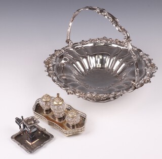 A silver plated chamber stick with snuffer 7cm, a silver plated and cut glass 3 bottle desk set on a shaped stand (chips to bottles in places), together with a circular pedestal cake basket with swing handle 31cm 