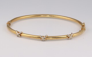 A 9ct yellow gold hollow bangle with swag decoration (dents in places), 4.1 grams 