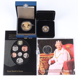 A 2012 Diamond Jubilee silver proof 5 pound,  a 2012 Diamond Jubilee coin set, a Royal Shield of Arms coin set and a 2017 Nations of the Crown silver proof 1 pound - all in original cases and sealed 