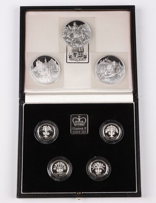 A Royal Mint 1984-1987 1 pound silver proof piedfort collection comprising four 1 pound coins and an ingot in fitted black case together with three silver medals from the Churchill Centenary Silver Medals Collection 1974 (81 grams)