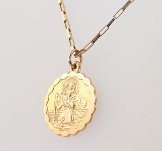 A 9ct yellow gold fine link chain, 44cm, hung a 9ct gold St Christopher pendant, 4.9 grams