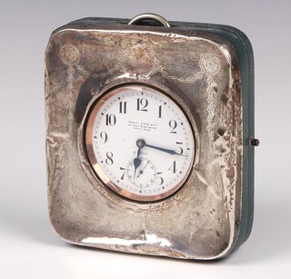 A Goliath 8 day open faced keyless travel clock, the enamelled dial with Arabic numerals and subsidiary second hand, marked Hardy Brothers Sydney and Brisbane, Swiss Made, contained in a silver travelling case, Birmingham 1911  