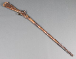 A 19th Century native percussion lock rifle with 96cm barrel, complete with ram rod  
