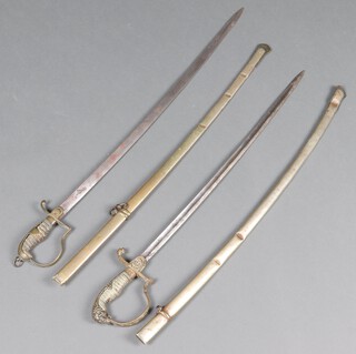 Two Turkish swords with 72cm curved blades, the gilt grips with crescents and stars, complete with scabbards, 1 has signature to the blade, the other has a plain blade