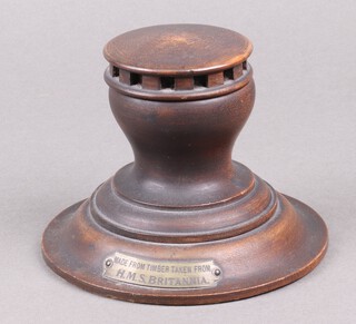 A circular turned mahogany capstan inkwell in the form of a capstan, marked Made from timber of HMS Britannia 10cm x 13cm 