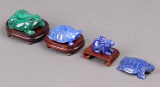 A carved malachite figure of a toad 6cm on a wooden stand, 3 Chinese carved hard bluestone figures of 2 turtles 5cm and a hare 2cm